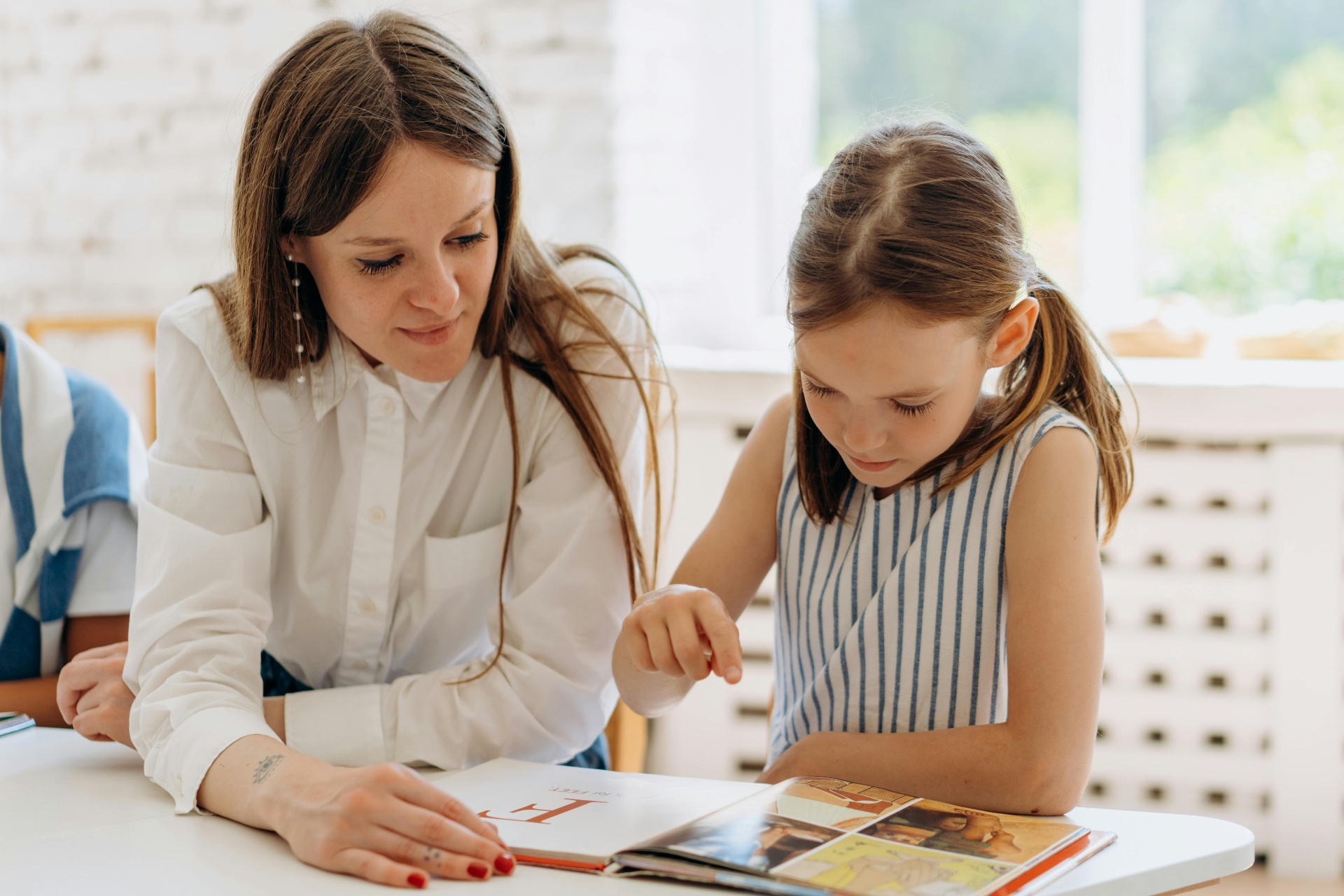 Tutor and student reading together