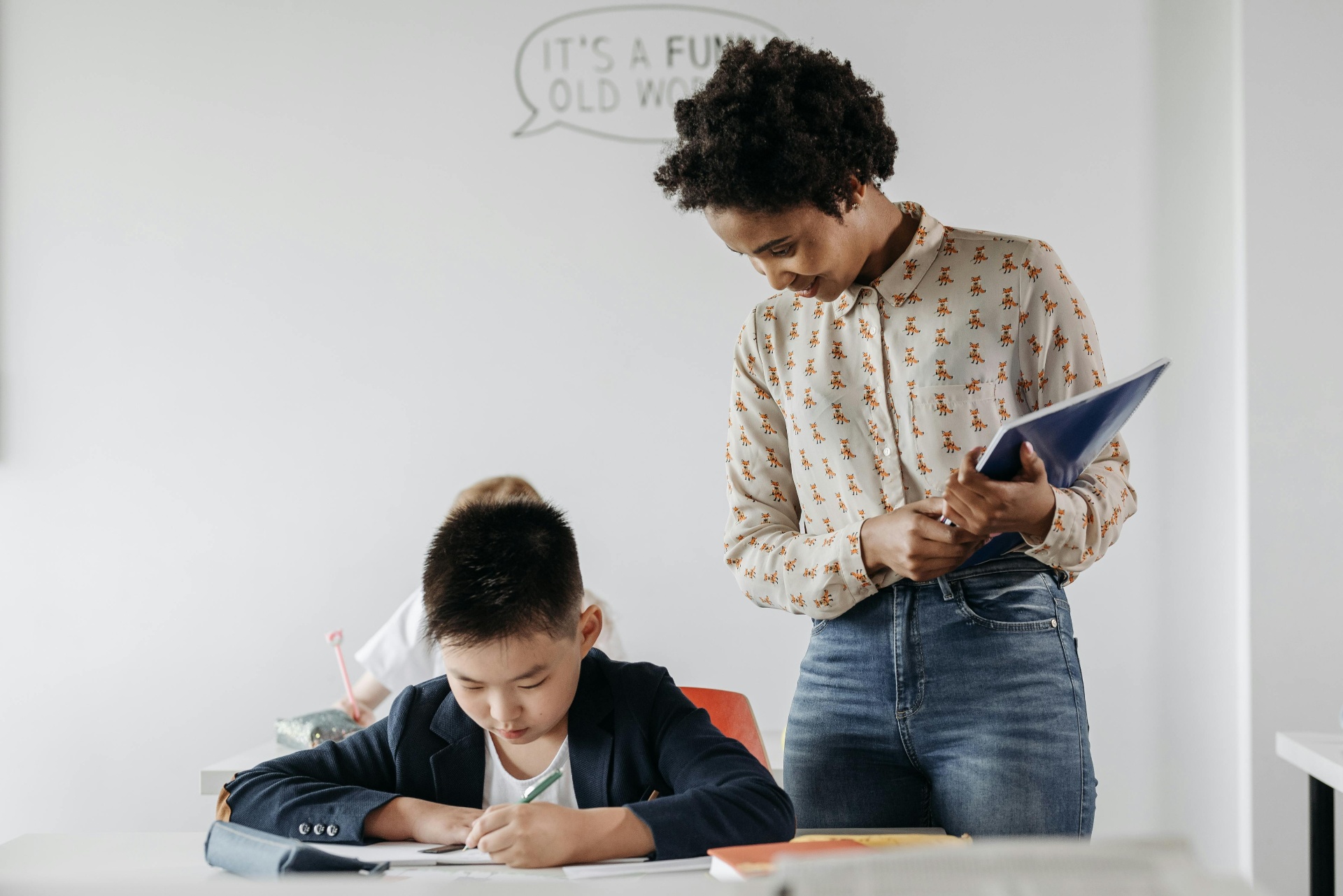 Teacher supervising student learning